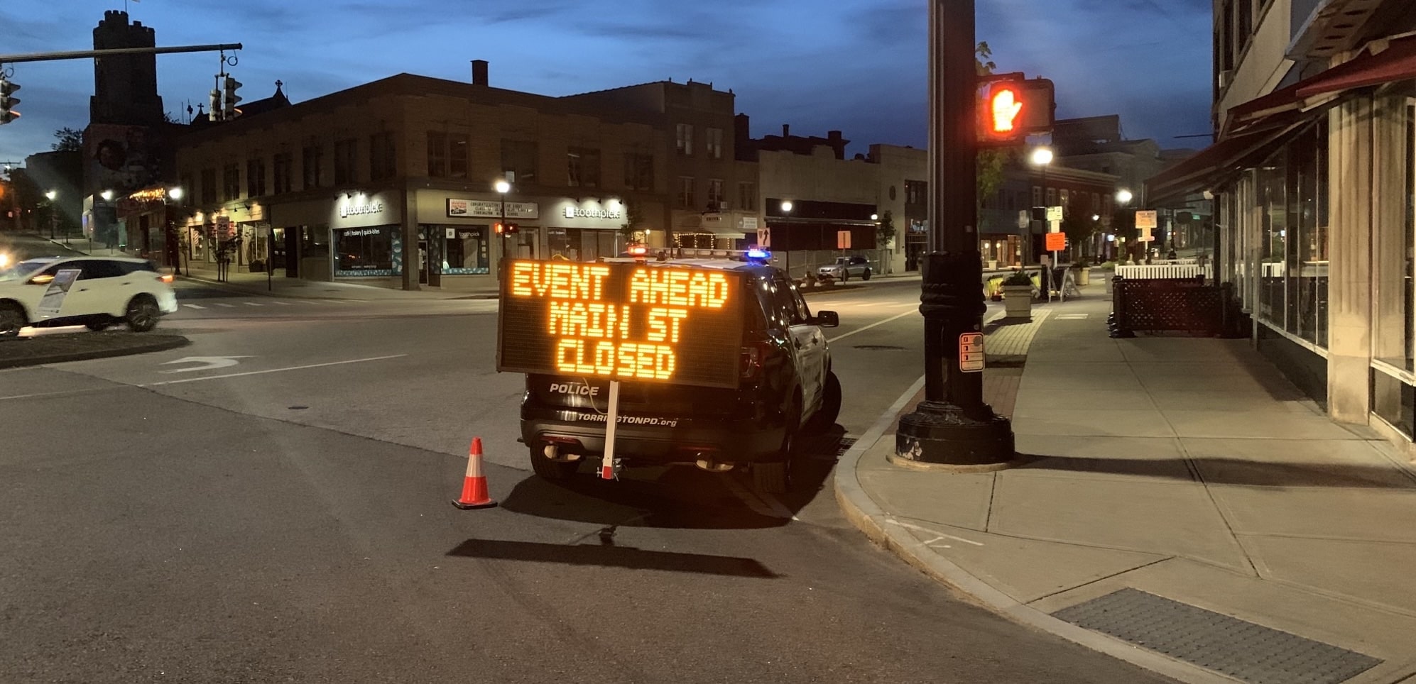 Portable changeable message sign on a vehicle hitch sharing information about a town event